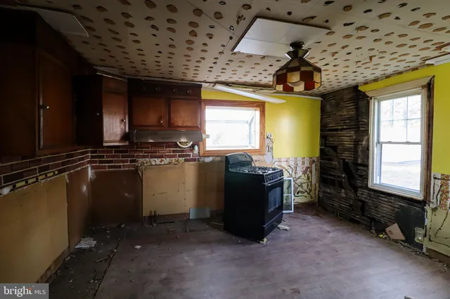 a kitchen with stainless steel appliances granite countertop a stove a refrigerator and a microwave