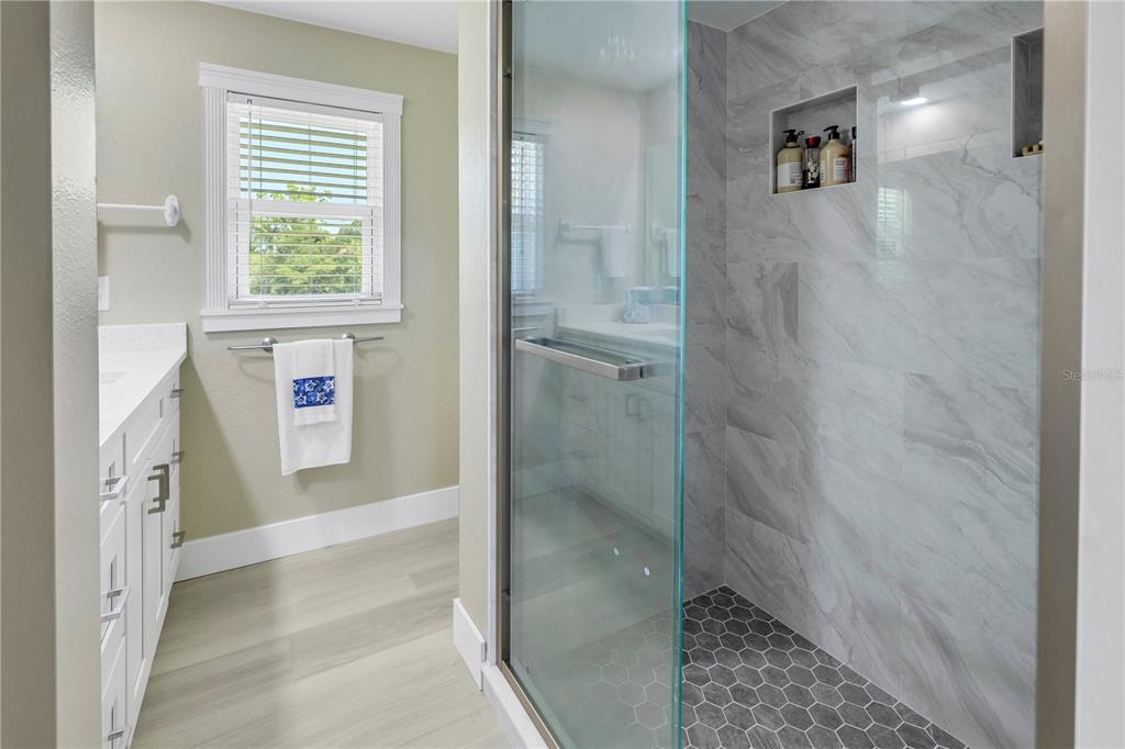 592 Ken Hubbard Road Terra Ceia, FL 34250 - Photo 20 of 34 a bathroom with a bathtub and a shower