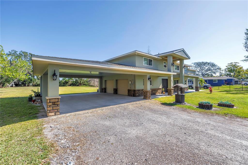 592 Ken Hubbard Road Terra Ceia, FL 34250 - Photo 2 of 34 a view of a house with a yard and garage