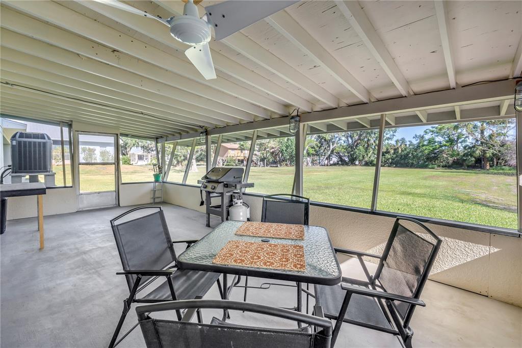 592 Ken Hubbard Road Terra Ceia, FL 34250 - Photo 26 of 34 a view of an outdoor dining space with furniture and garden view