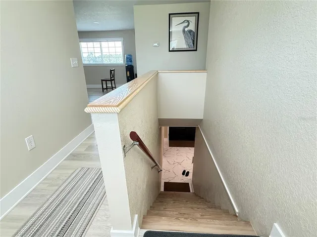 a workspace with wooden floor and windows