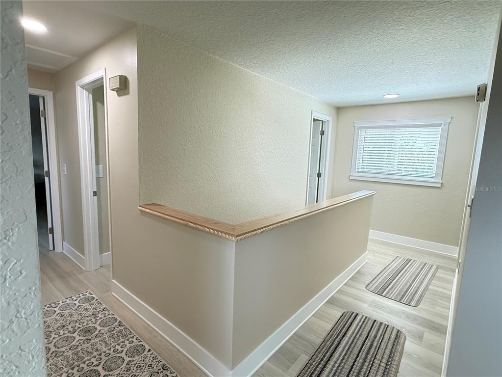 592 Ken Hubbard Road Terra Ceia, FL 34250 - Photo 10 of 34 a view of a bedroom with wooden floor and windows
