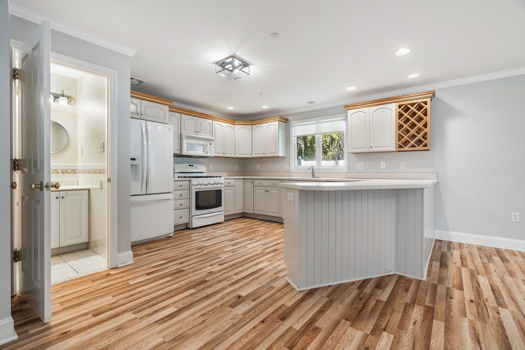 216 Rangeway Road, Unit 192 Billerica, MA 01862 - Photo 6 of 18 a open kitchen with kitchen island white cabinets and stainless steel appliances