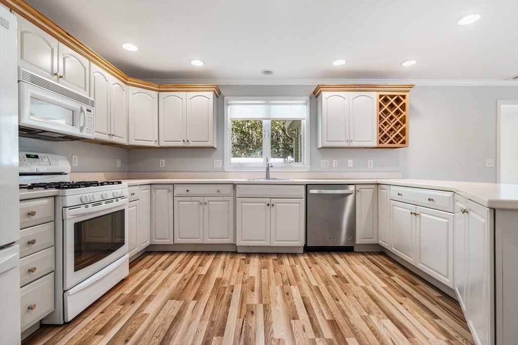 216 Rangeway Road, Unit 192 Billerica, MA 01862 - Photo 7 of 18 a kitchen with white cabinets stainless steel appliances and sink