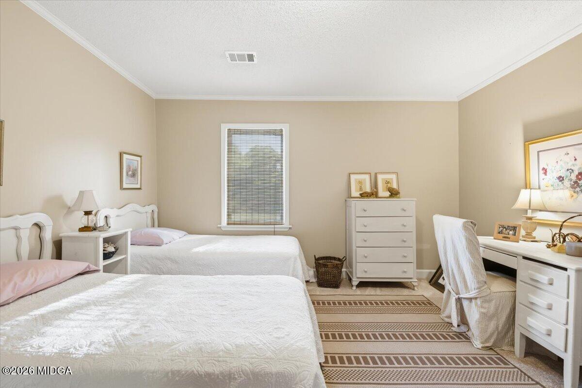 214 Howard Roberts Road Gray, GA 31032 - Photo 19 of 36 a bedroom with a bed a couch and dresser