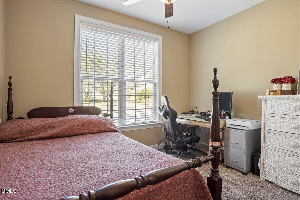 1001 Bellewood Farms Road Raleigh, NC 27603 - Photo 32 of 39 a bedroom with a bed and a table