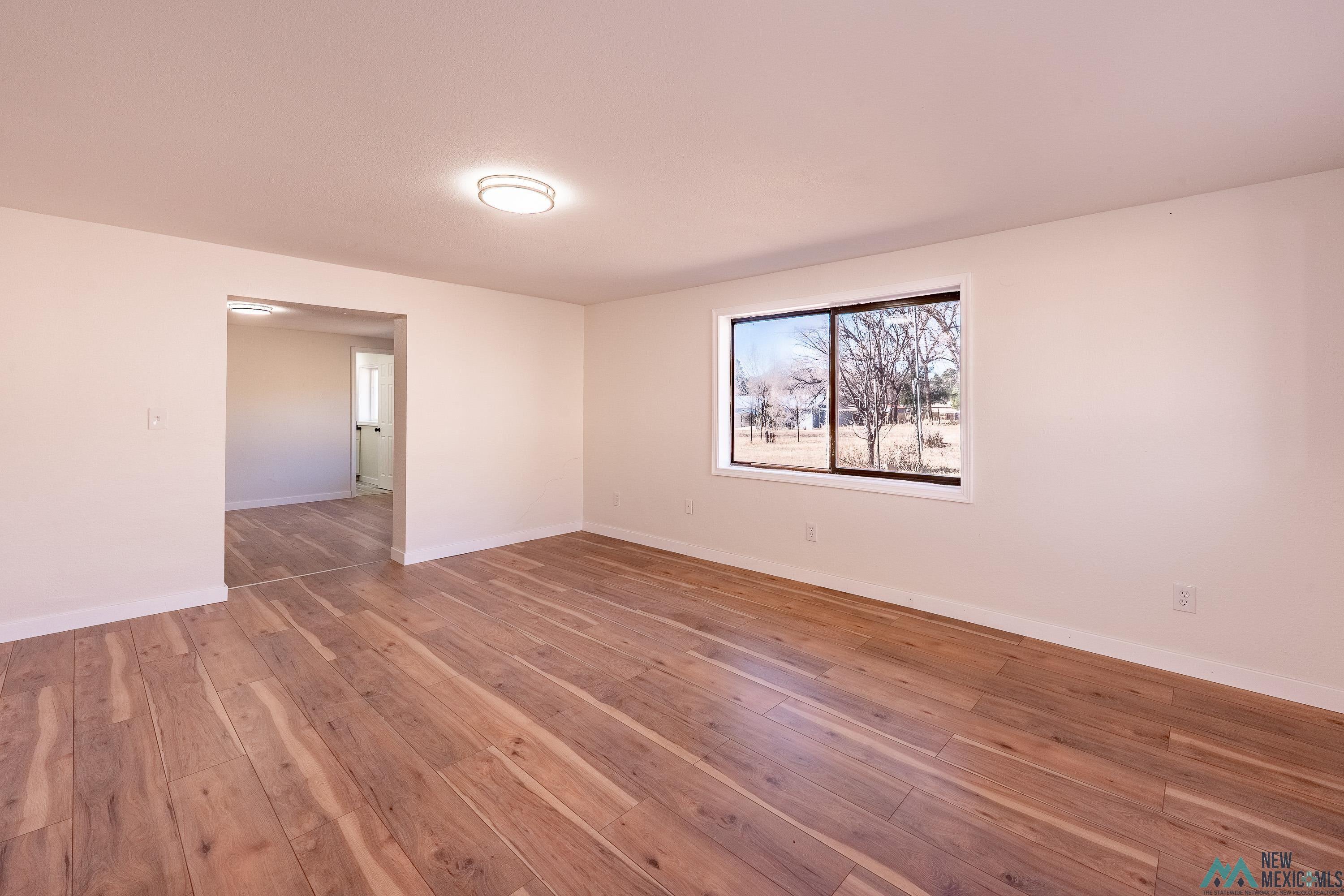 1131 Lincoln Avenue Raton, NM 87740 - Photo 20 of 41 Spare room featuring hardwood / wood-style floors and baseboards