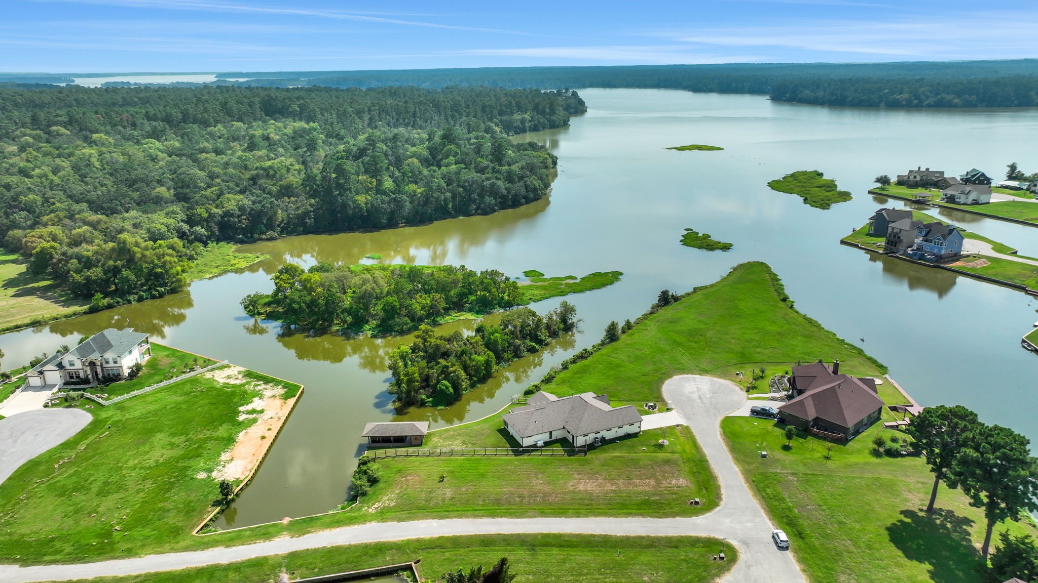 11 Peninsula Point Huntsville, TX 77340 - Photo 5 of 18 a view of a lake with a yard