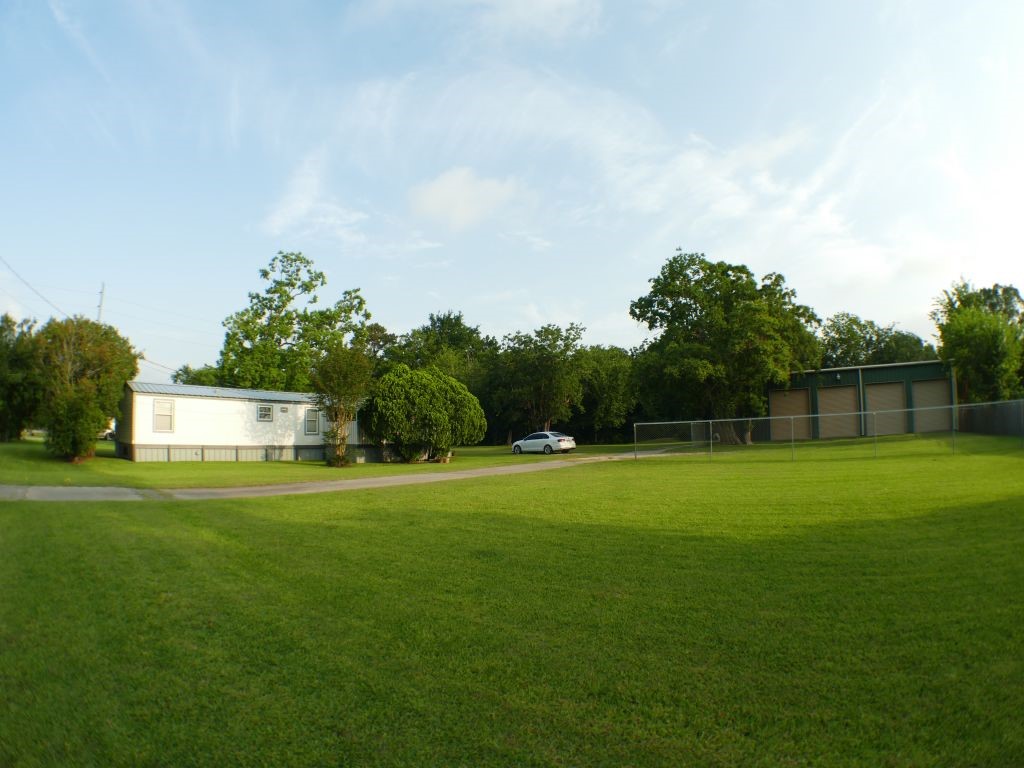 a backyard of a house with lots of green space