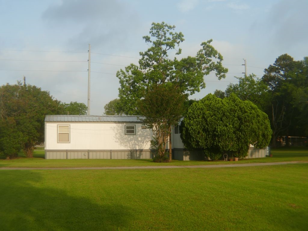 1615 East Wallisville Road Highlands, TX 77562 - Photo 2 of 32 a front view of a house with a yard and trees