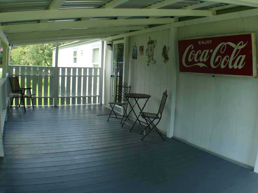 1615 East Wallisville Road Highlands, TX 77562 - Photo 23 of 32 a view of a patio with table and chairs with wooden floor