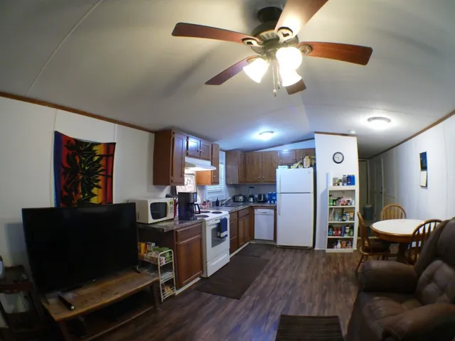 a living room with furniture a dining table and a piano table