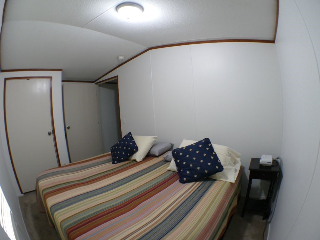 1615 East Wallisville Road Highlands, TX 77562 - Photo 30 of 32 a bedroom with a bed and wooden floor