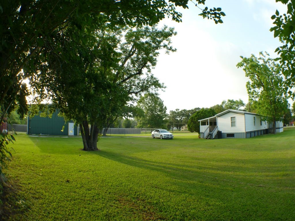 1615 East Wallisville Road Highlands, TX 77562 - Photo 4 of 32 a view of a house with a big yard