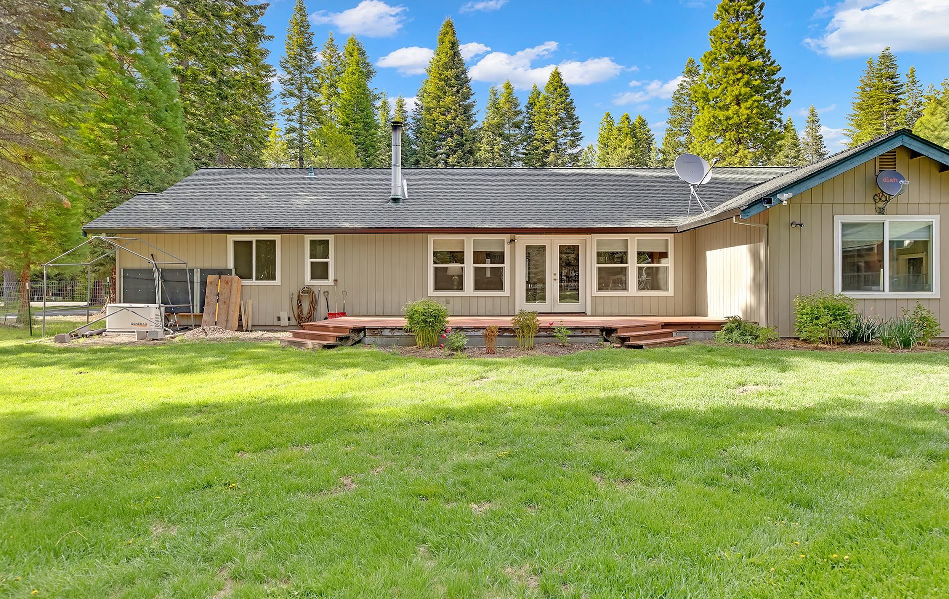 650 Wagon Road Chester, CA 96020 - Photo 31 of 36 a front view of a house with a yard and trees