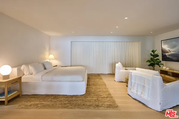 a bedroom with a bed and a couch