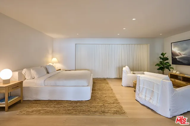 a bedroom with a bed and a couch