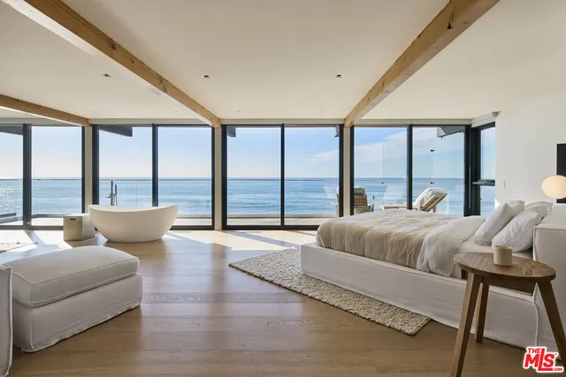 a bedroom with a large bed and a large window