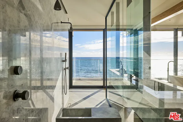 a bathroom with a glass shower door