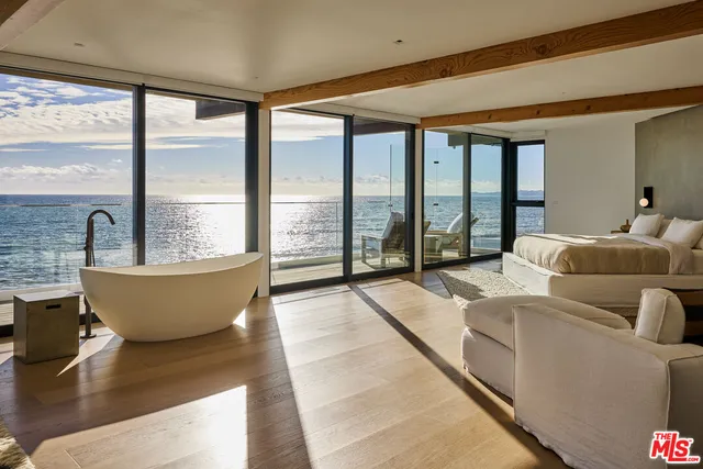 a living room with furniture and large windows