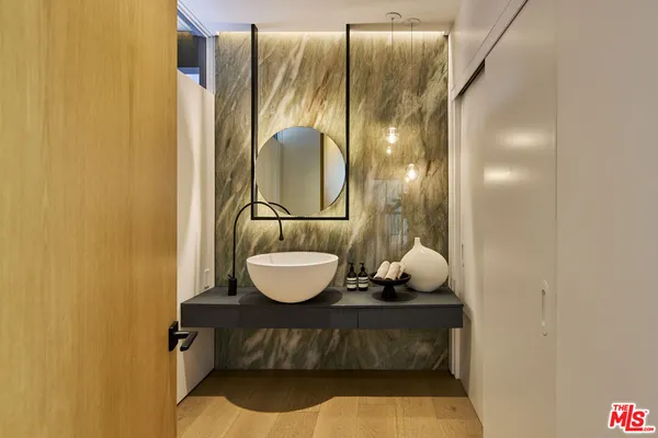 a bathroom with a sink and mirror