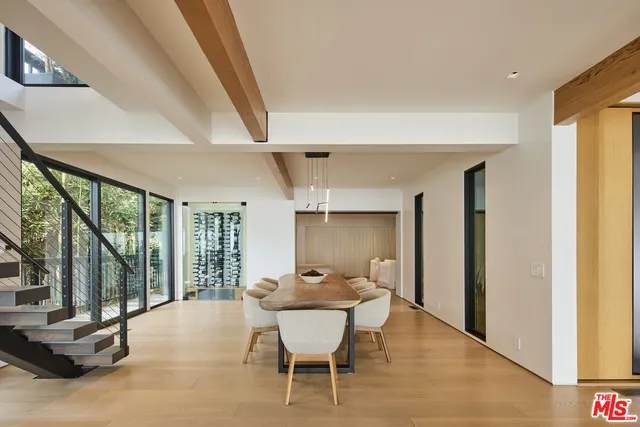 a living room with furniture and large windows