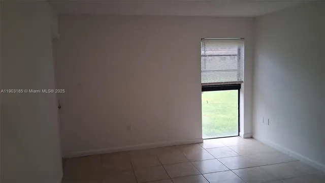 a view of an empty room and a window