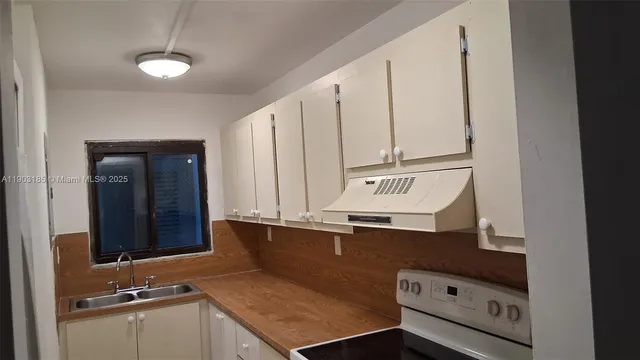 a view of a bathroom with a sink and a mirror