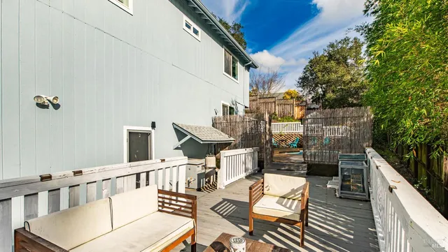 a backyard of a house with table and chairs