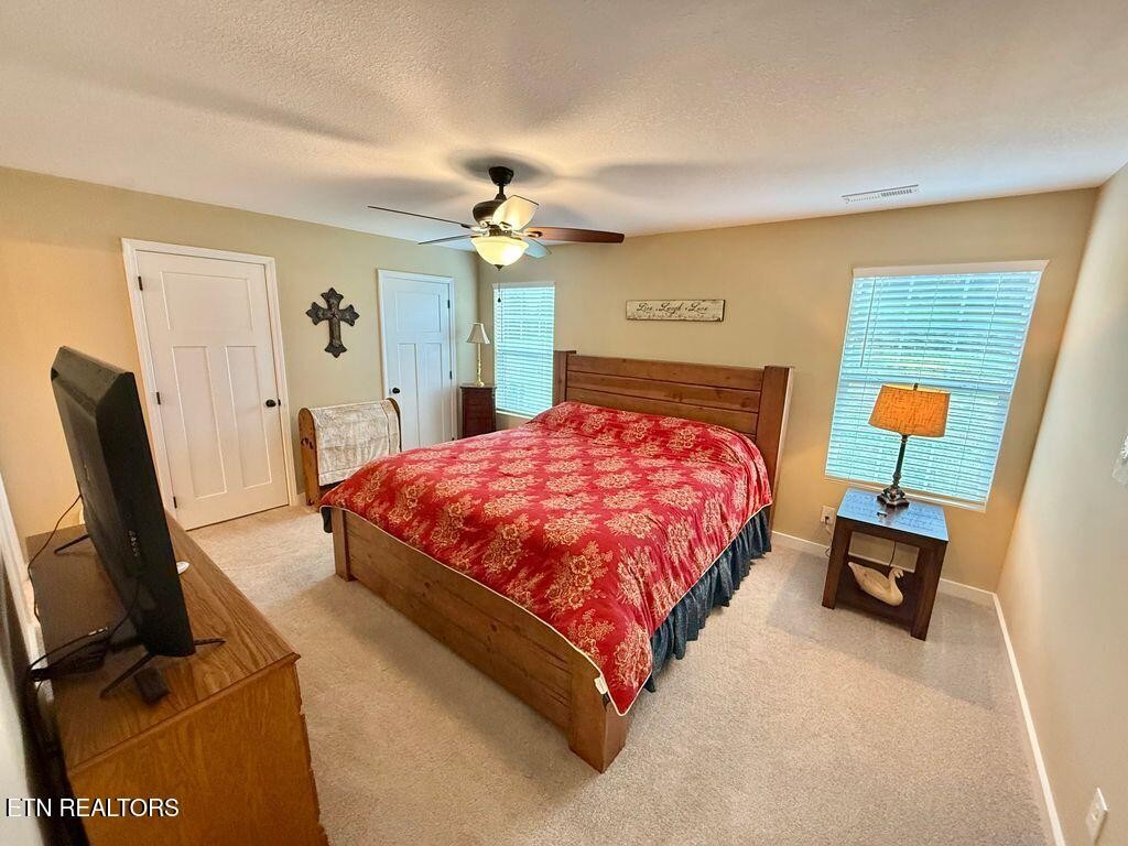 1825 Pleasant View Cemetery Road New Market, TN 37820 - Photo 4 of 19 a bedroom with a bed a couch and a dresser with wooden floor