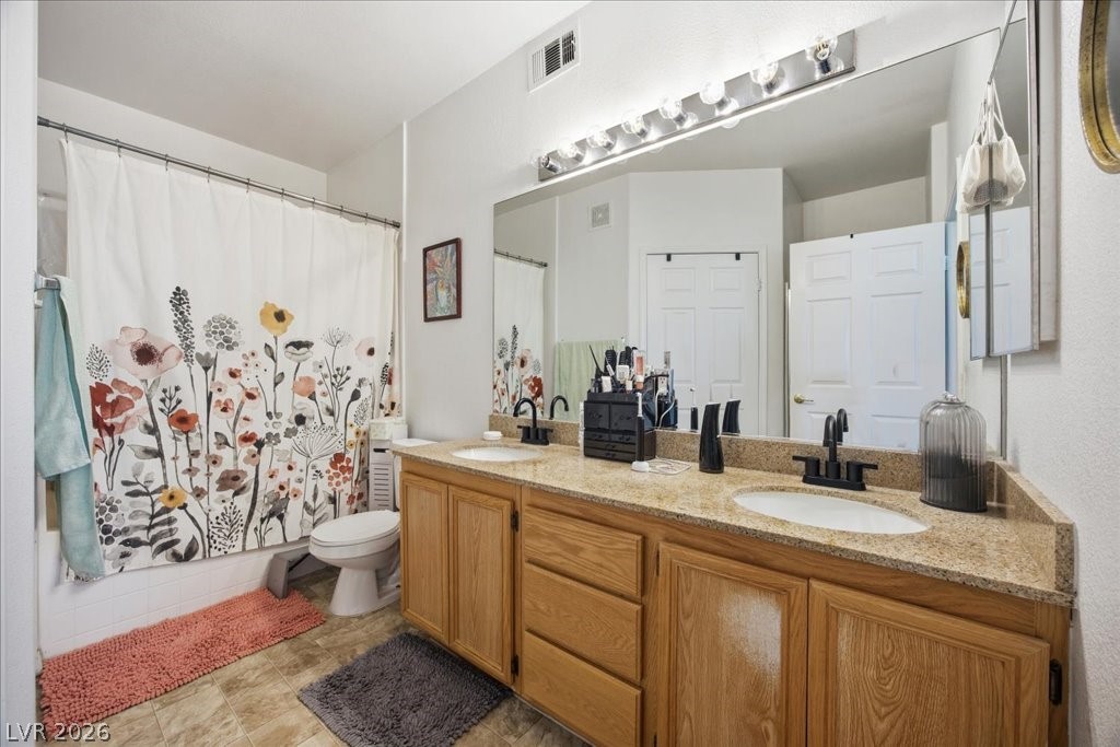 10550 West Alexander Road, Unit 2164 Las Vegas, NV 89129 - Photo 15 of 27 A well-appointed bathroom offers a double vanity with granite counters, ideal for daily routines.