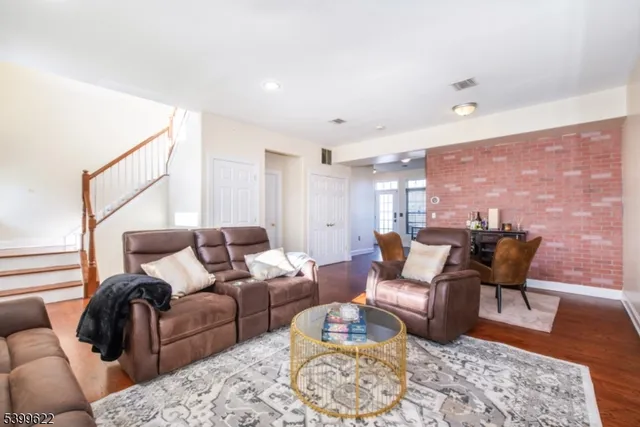 a living room with furniture wooden floor and a rug