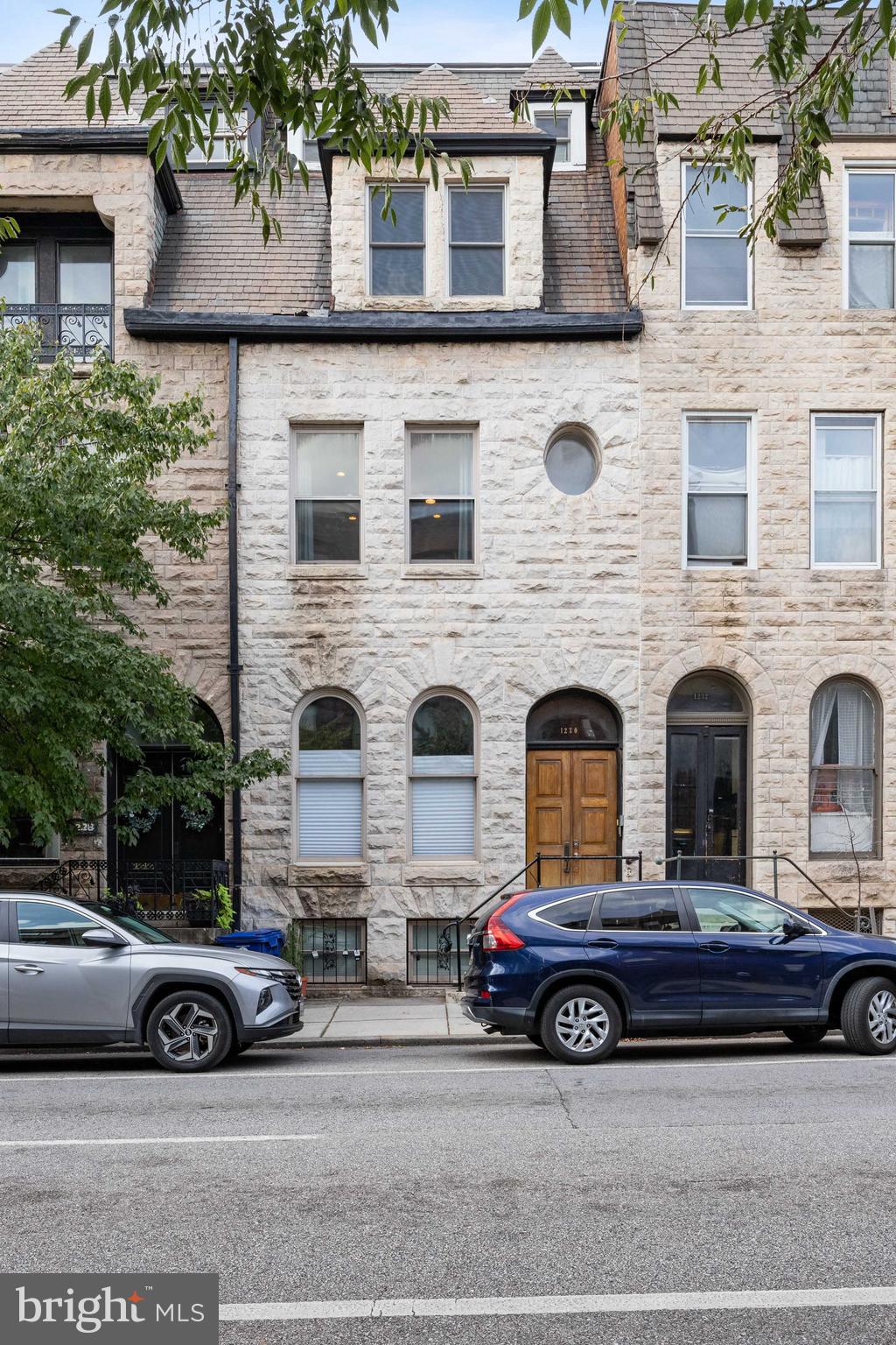 a car parked in front of a brick house