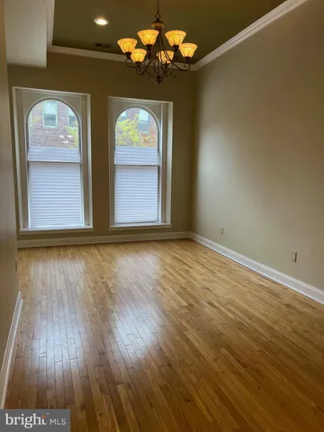 a view of room with wooden floor