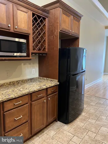 a kitchen with stainless steel appliances granite countertop a stove and a microwave