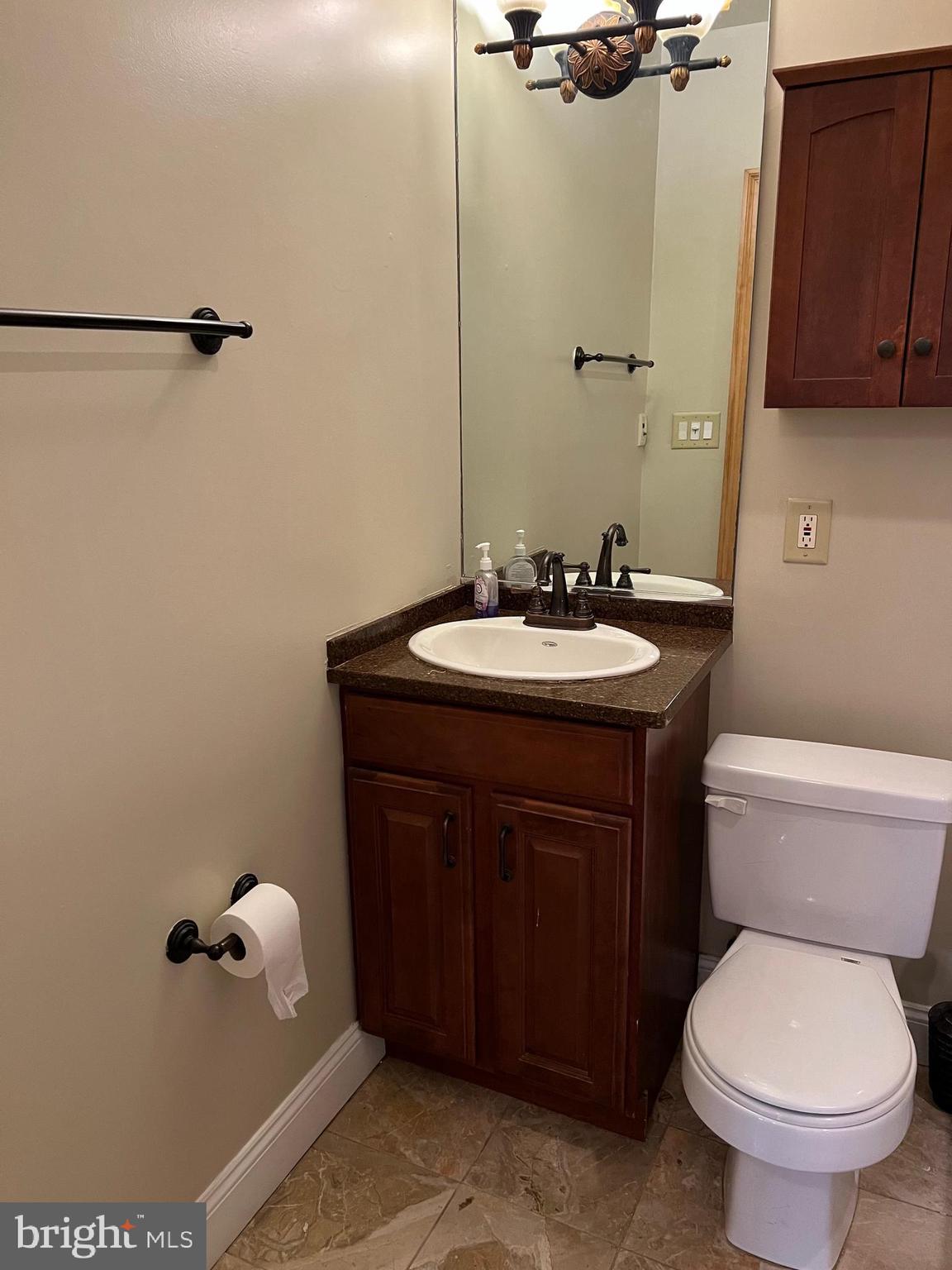 1230 North Calvert Street, Unit 1 Baltimore, MD 21202 - Photo 8 of 14 a bathroom with a sink a toilet and mirror