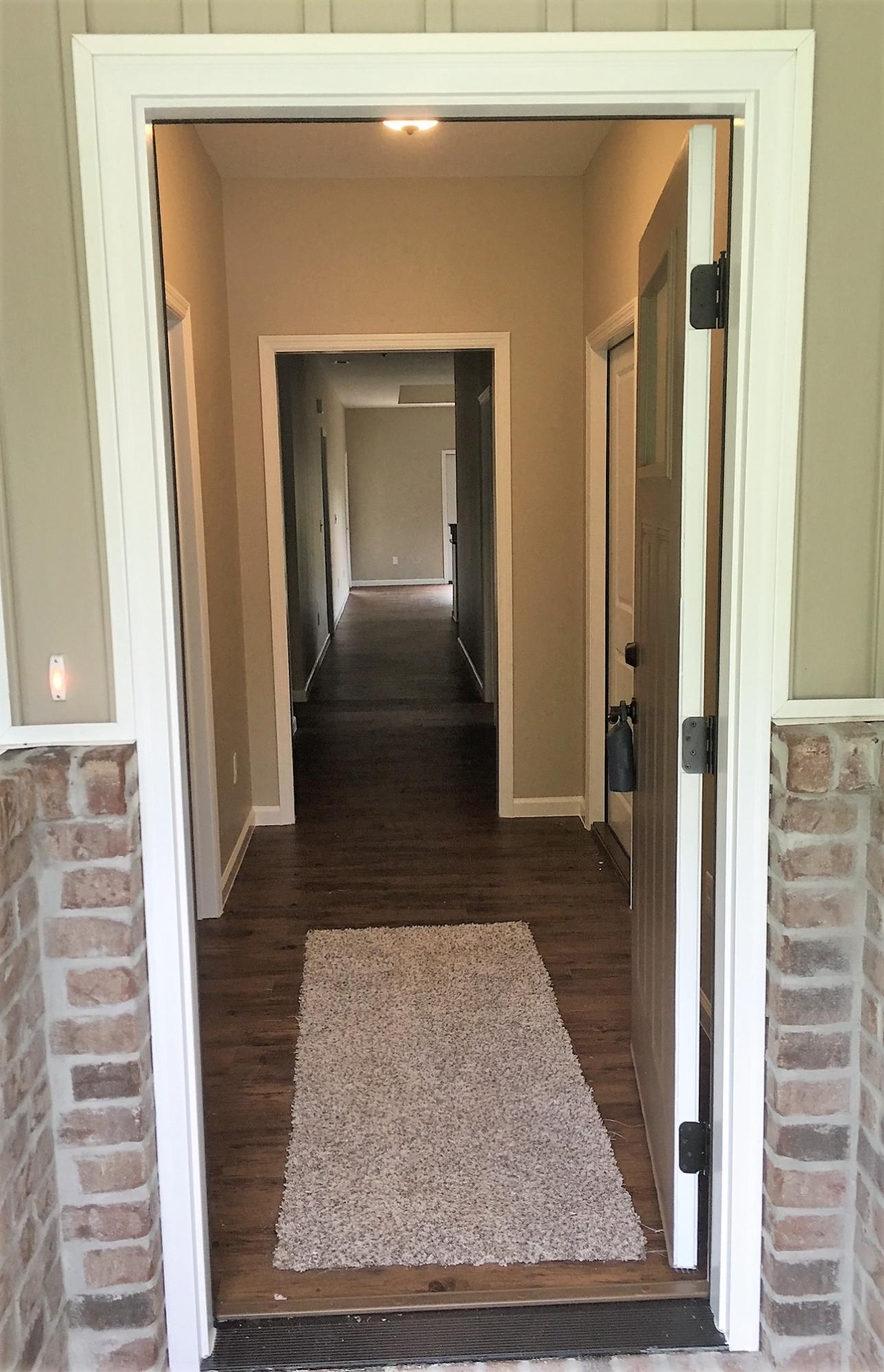 240 Dixie Street Crestview, FL 32536 - Photo 2 of 20 a view of a hallway with wooden floor and staircase