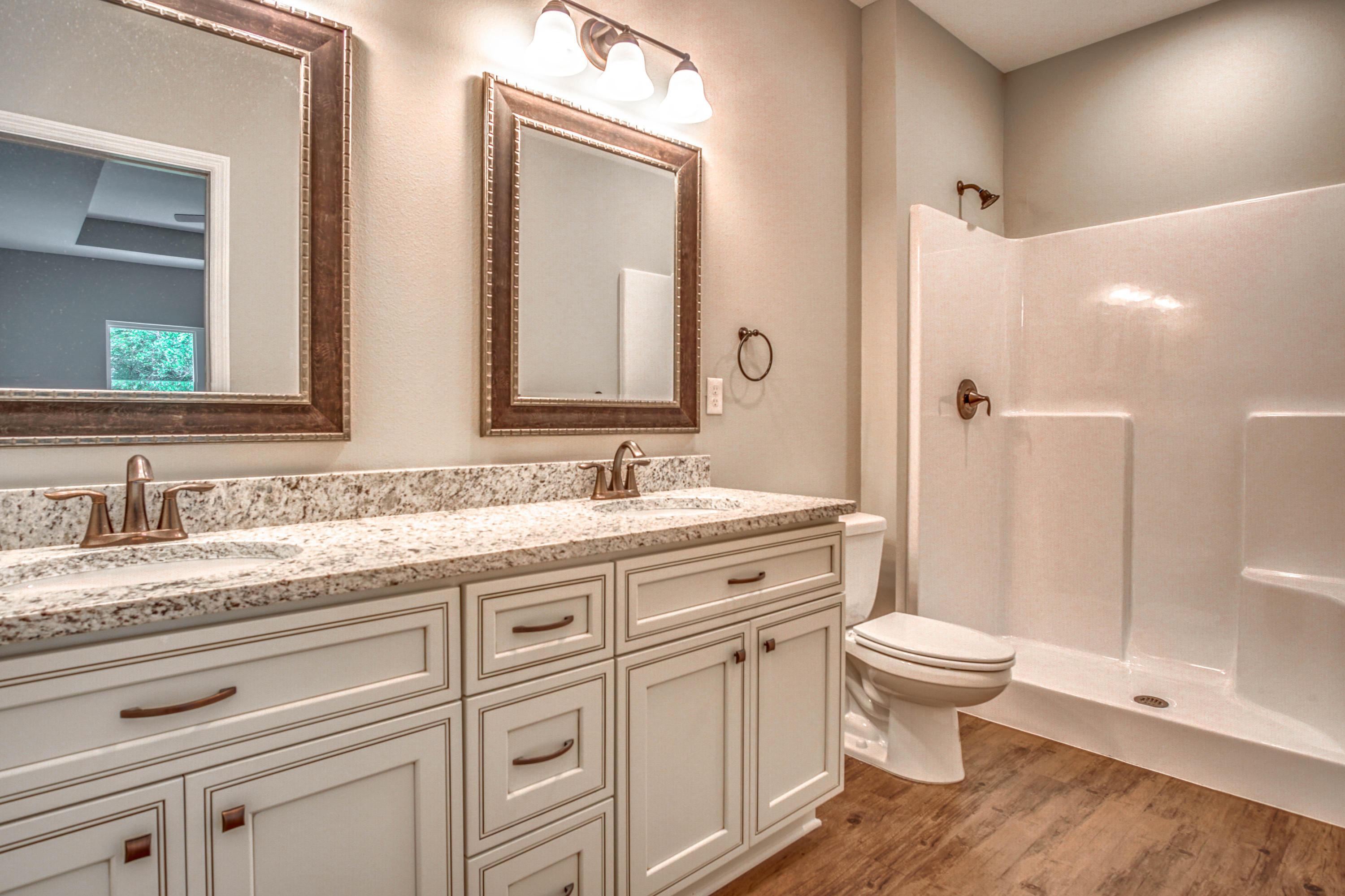 240 Dixie Street Crestview, FL 32536 - Photo 13 of 20 a spacious bathroom with a granite countertop sink toilet a mirror and shower