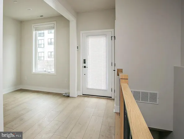 an entryway of a house with wooden floor