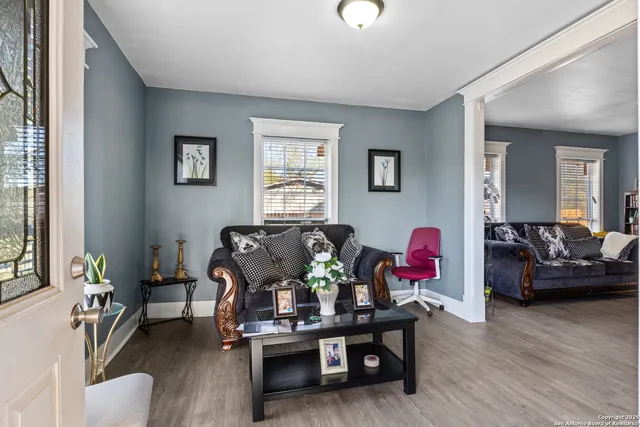 a living room with furniture and wooden floor
