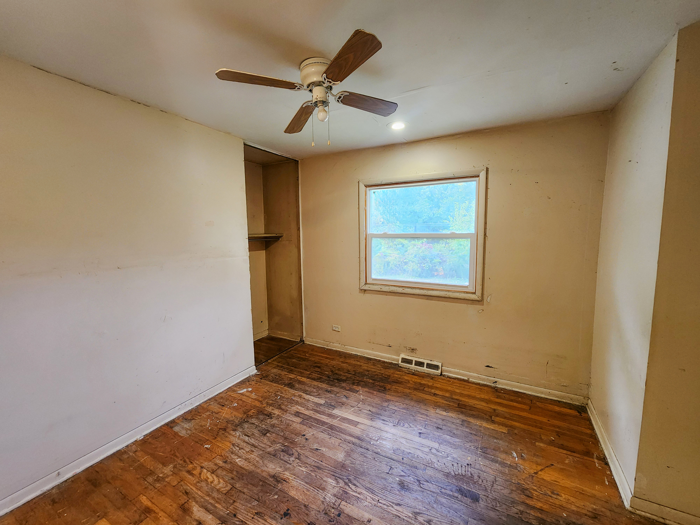 3236 Roesner Drive Markham, IL 60428 - Photo 8 of 12 an empty room with wooden floor chandelier fan and windows