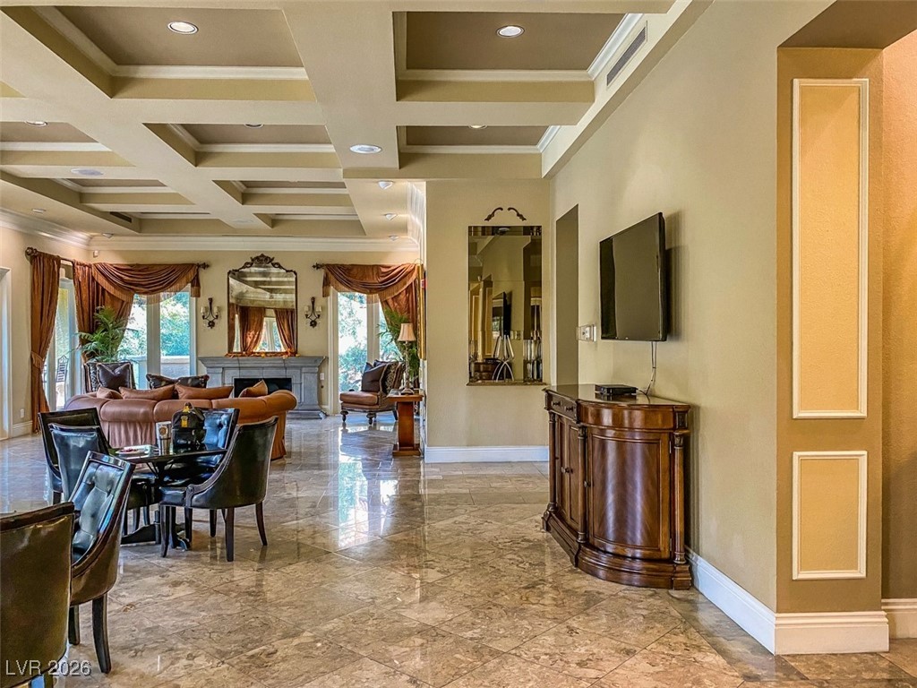 260 East Flamingo Road, Unit 229 Las Vegas, NV 89169 - Photo 11 of 41 Dining space with crown molding, a fireplace, coffered ceiling, light marble finish floors, and recessed lighting