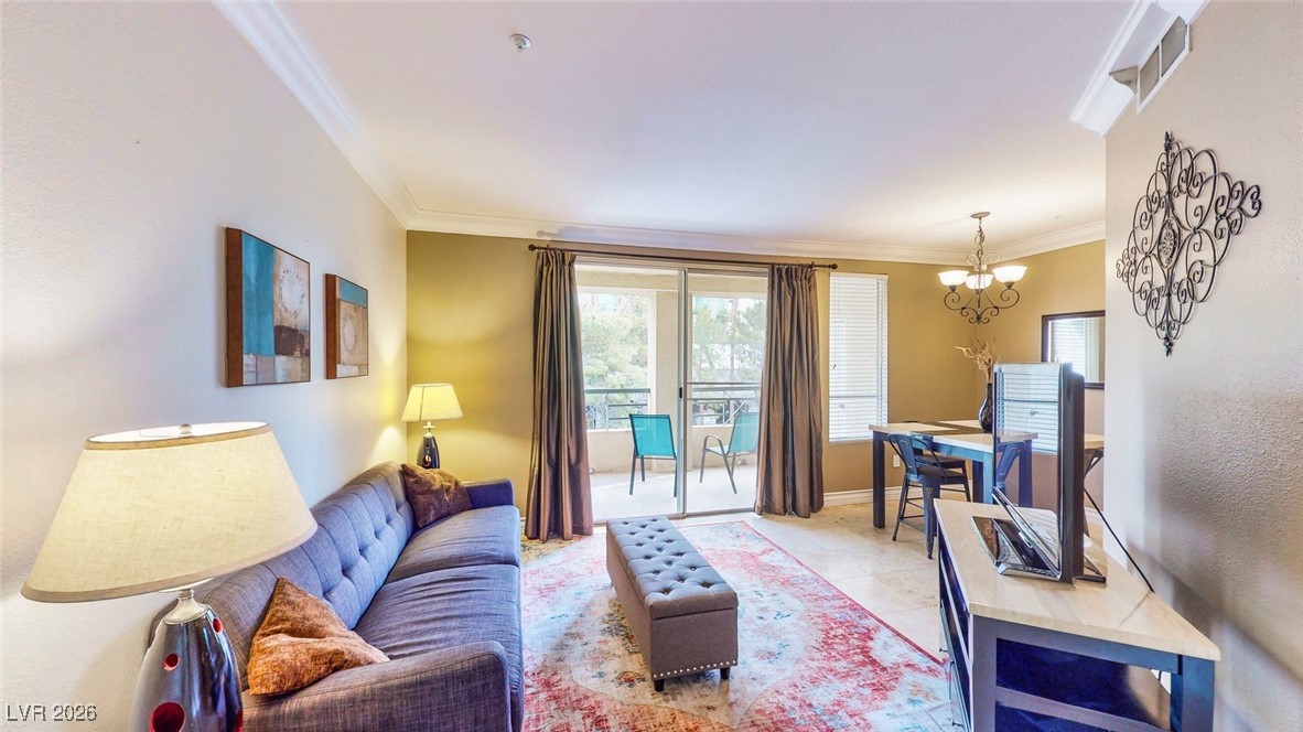 260 East Flamingo Road, Unit 229 Las Vegas, NV 89169 - Photo 25 of 41 Living area featuring crown molding and suspended lighting