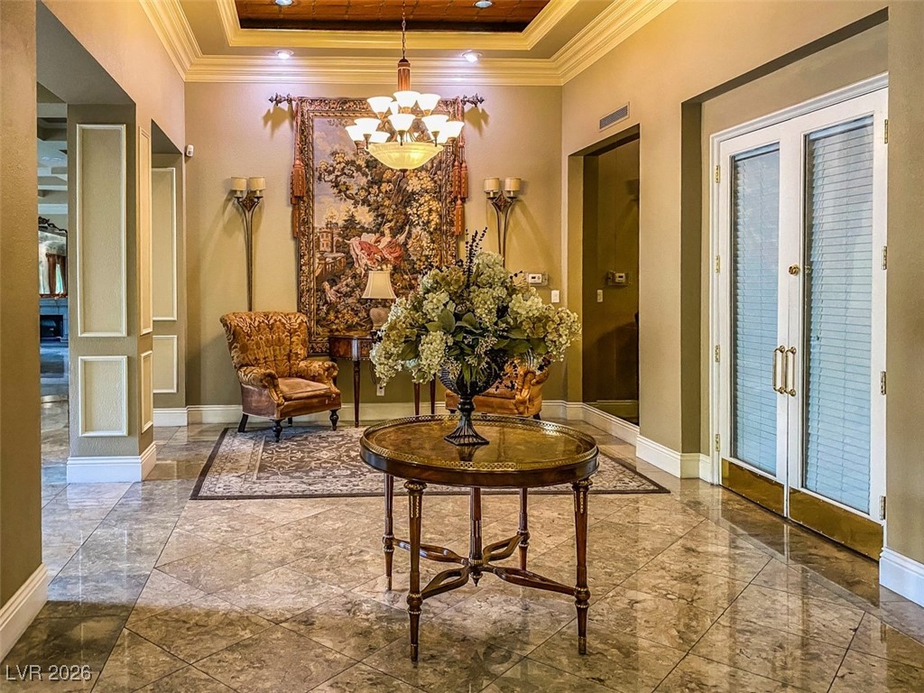 260 East Flamingo Road, Unit 229 Las Vegas, NV 89169 - Photo 10 of 41 Sitting room featuring crown molding, french doors, a raised ceiling, and a chandelier