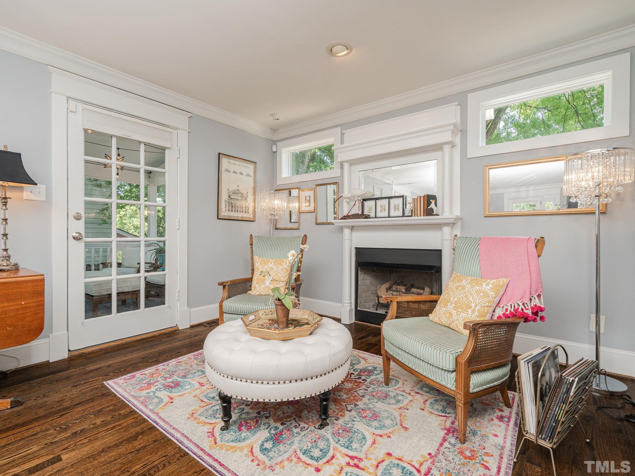 630 New Road Raleigh, NC 27608 - Photo 21 of 55 a living room with furniture a fireplace and a window