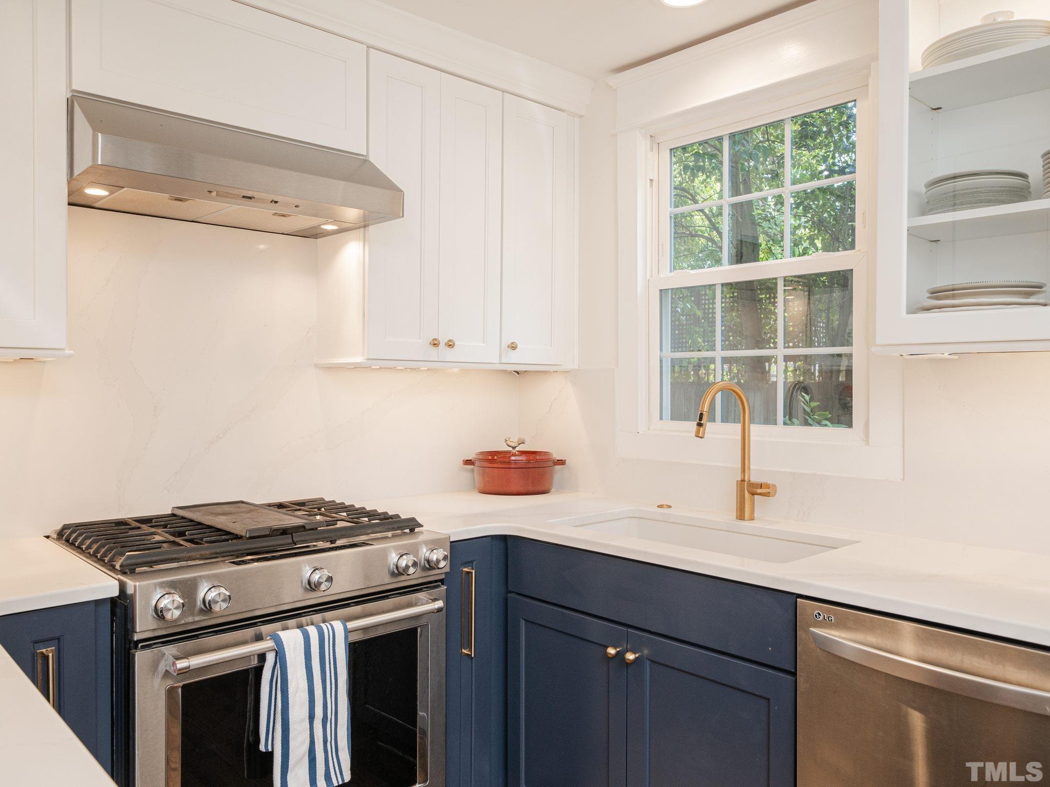 630 New Road Raleigh, NC 27608 - Photo 29 of 55 a kitchen with a stove and a sink