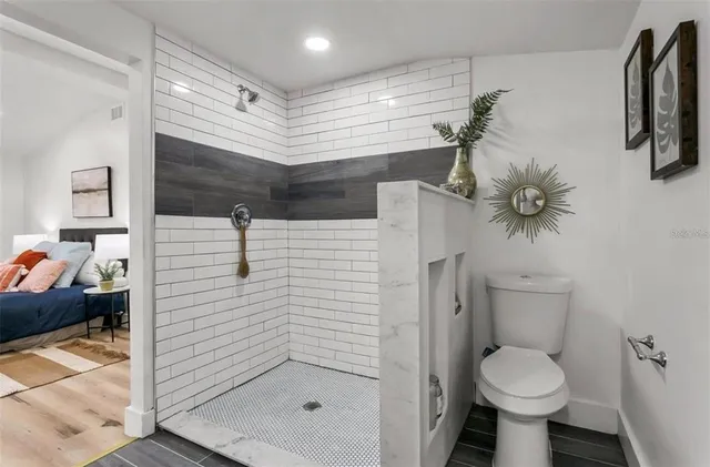 a bathroom with a toilet sink and shower