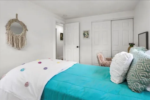 a bedroom with a bed and a chair