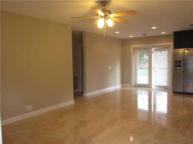 7010 Harding Street Hollywood, FL 33024 - Photo 2 of 9 wooden floor in an empty room with a window