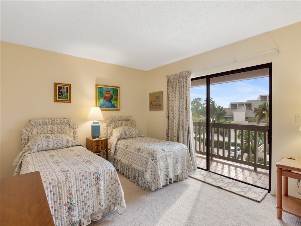 1880 Bay Road, Unit I319 Vero Beach, FL 32963 - Photo 17 of 36 a bedroom with two beds and large window